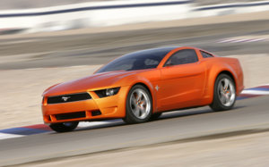 112_0703_06z-giugiaro_ford_mustang_concept-front_side_view_driving.jpg