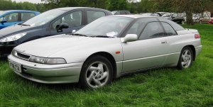 1200px-Subaru_SVX_in_parkland_in_the_British_West_Midlands_first_registered_February_1997_3317cc.jpg