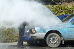 9202659-Man-looking-at-a-smoking-engine-in-his-car--Stock-Photo-breakdown.jpg