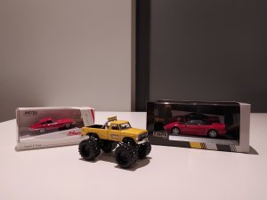 two_red_cars_and_a_yellow_truck.jpg