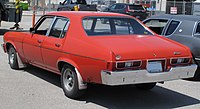 1973_Oldsmobile_Omega_Town_Sedan_in_Omega_Red_Rear_Left_05-29-2022.jpg